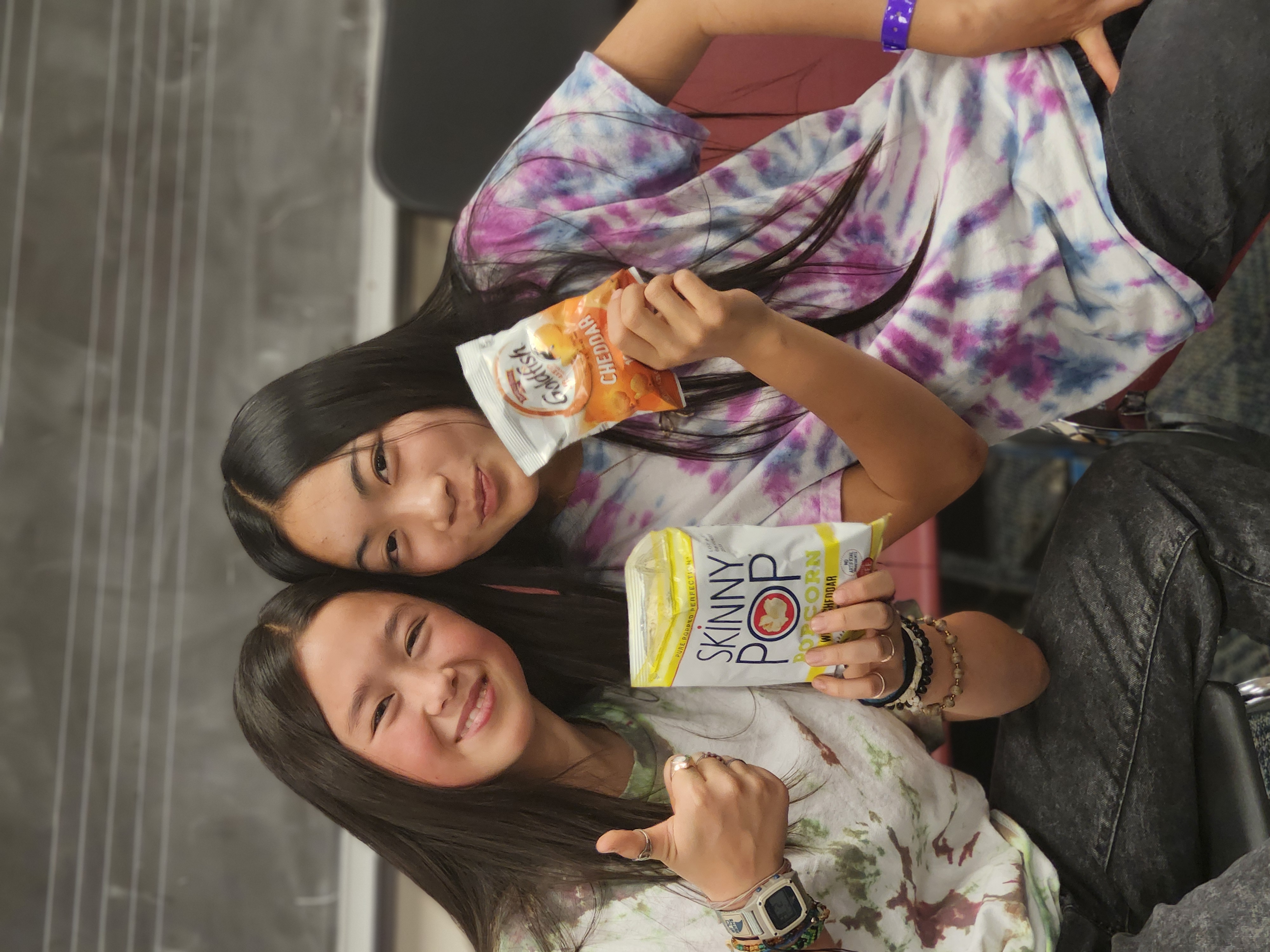 Two piano students eating chips